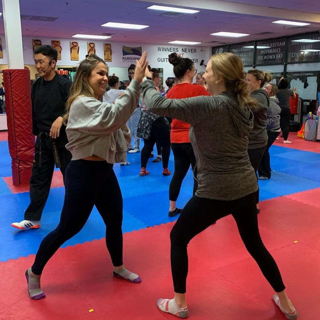 A womens self defense class practicing simple strikes together