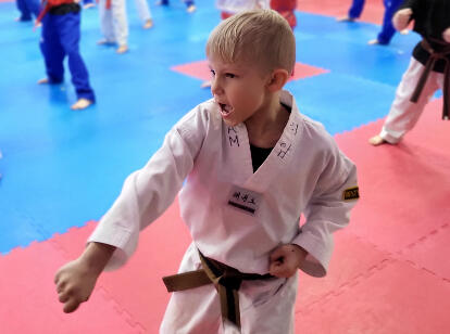 Kids Class Thumbnail A child executing a low block during class